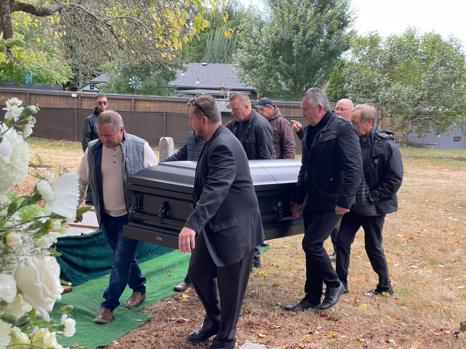 Pallbearers carrying a casket at the graveside